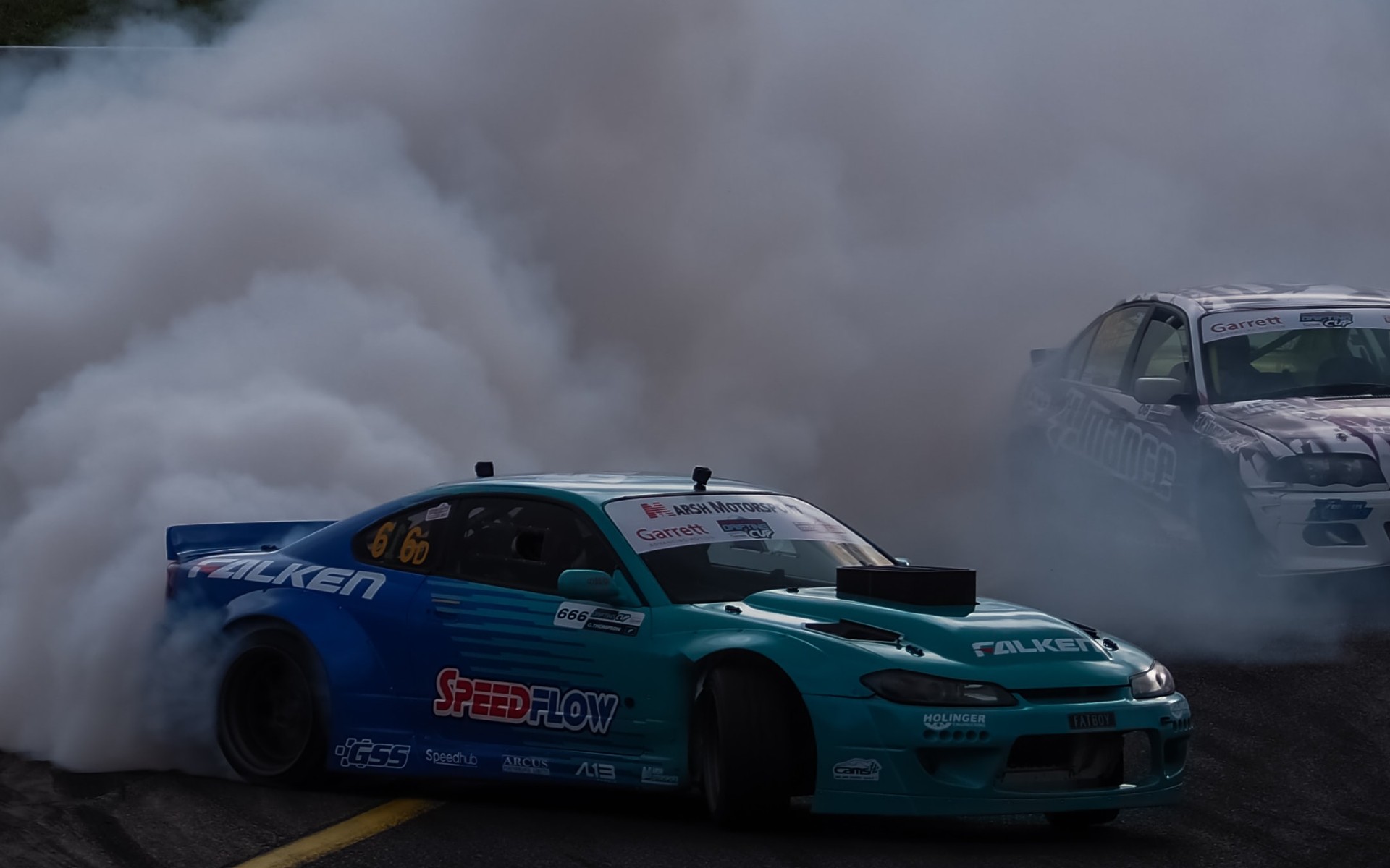 race cars in smoke